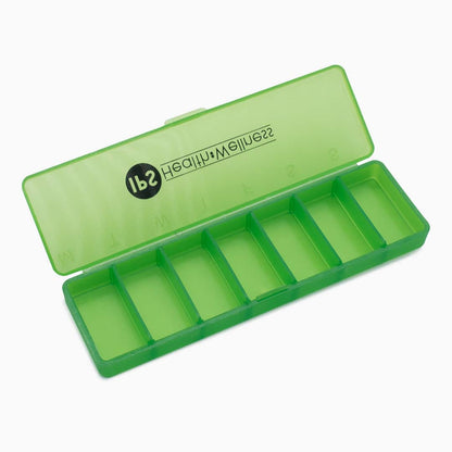 Open green IPS pill organiser showing seven compartments
